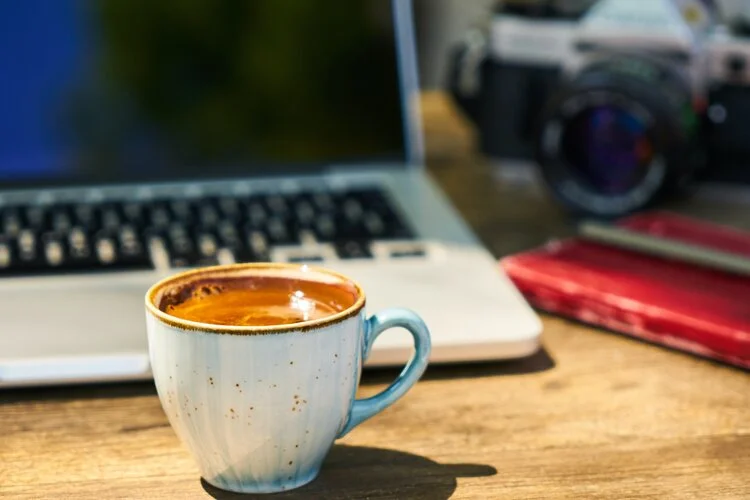 Coffee cup in front of Computer on desk