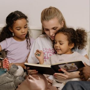 Mother and children looking at photo album